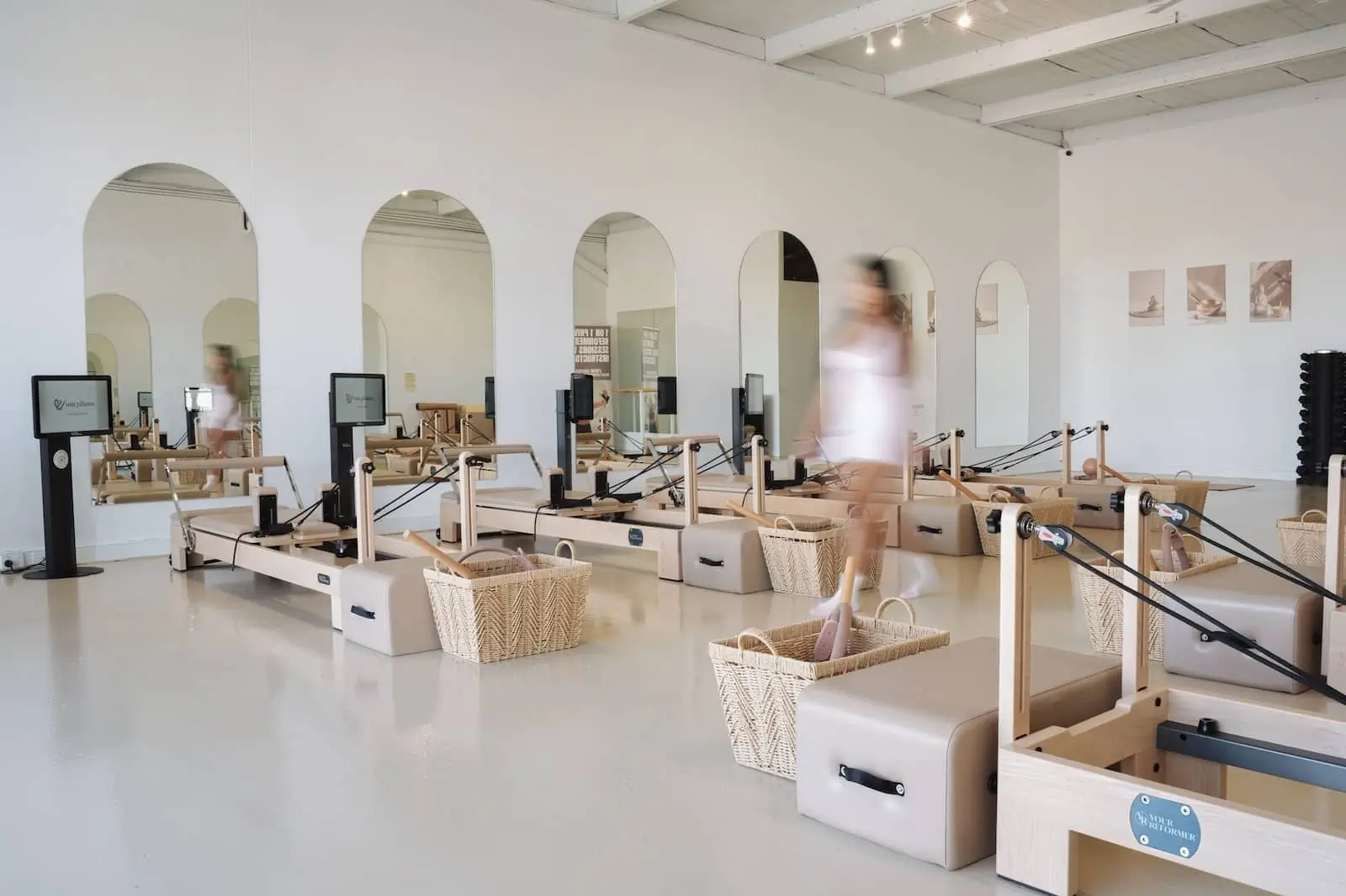 woman performing reformer pilates at om pilates Southport studio — boutique pilates studio near Brickworks, open 7 days
